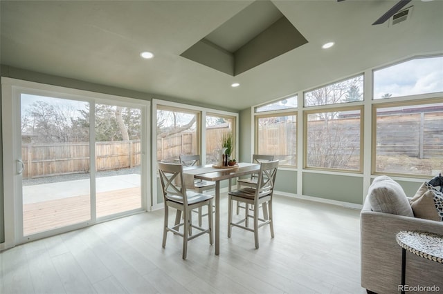 sunroom featuring vaulted ceiling and visible vents