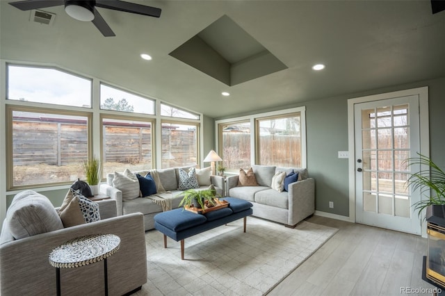 sunroom featuring vaulted ceiling, visible vents, and a ceiling fan