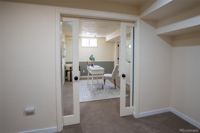 home office with carpet floors and baseboards