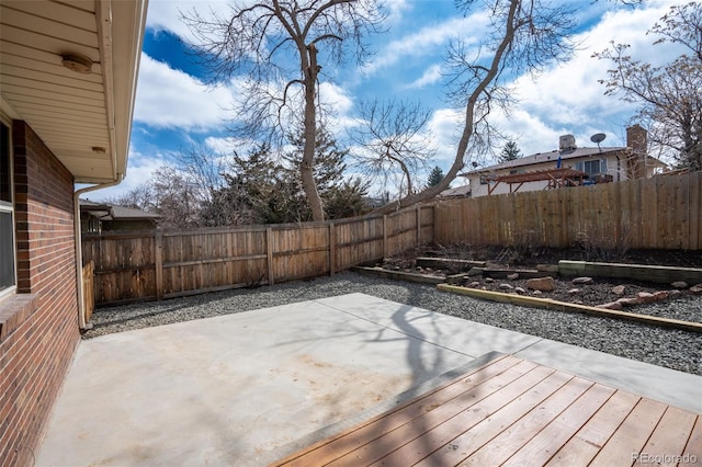 exterior space with a patio area and a fenced backyard