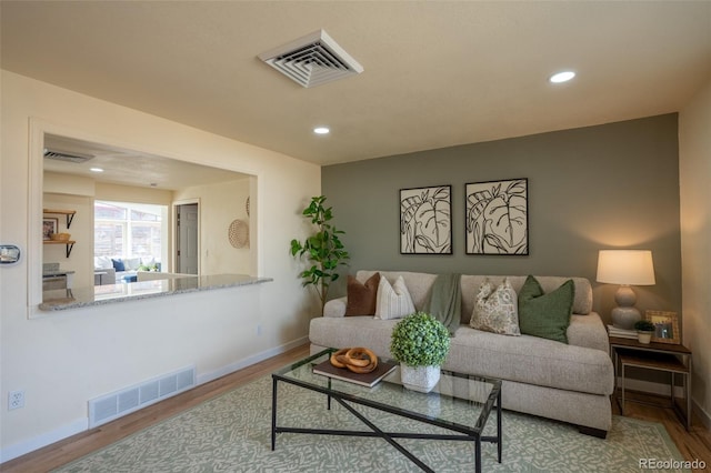 living area featuring wood finished floors and visible vents