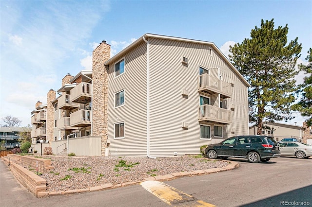 381 S Ames St Unit E305, Lakewood, CO 80226 - view of property featuring uncovered parking and fence