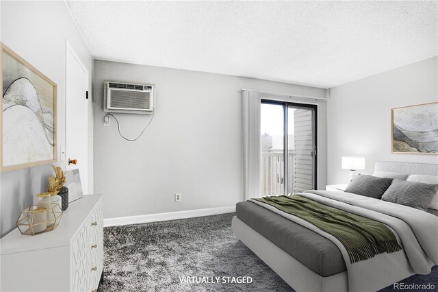 381 S Ames St Unit E305, Lakewood, CO 80226 - bedroom with a wall mounted air conditioner, carpet floors, access to exterior, and a textured ceiling