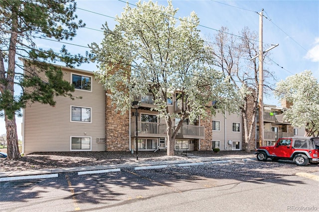 381 S Ames St Unit E305, Lakewood, CO 80226 - view of building exterior with uncovered parking