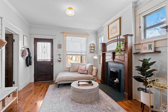 sitting room with hardwood / wood-style flooring and crown molding