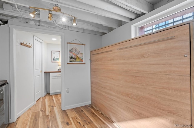 hallway featuring wine cooler and light wood-type flooring