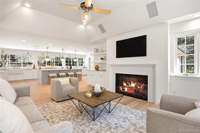 living area with recessed lighting, light wood-type flooring, and a wealth of natural light