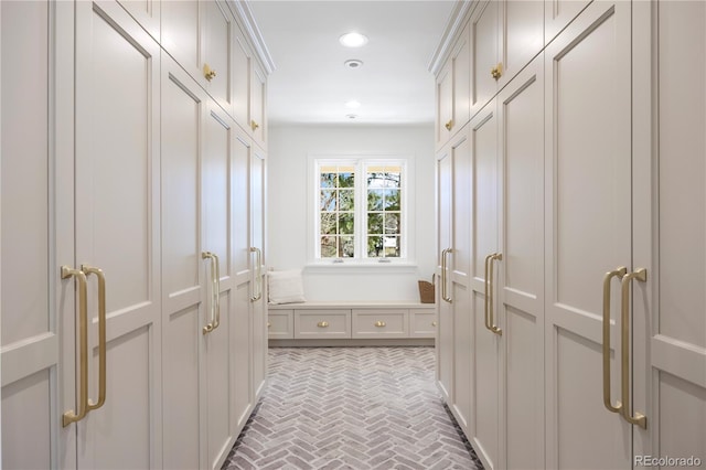 mudroom with brick patterned floor and recessed lighting