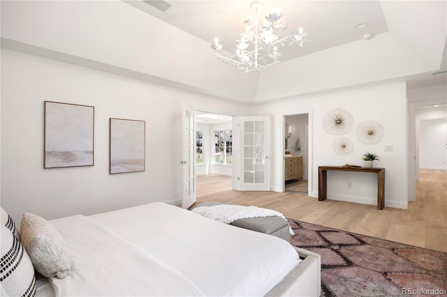 bedroom with light wood finished floors, connected bathroom, french doors, baseboards, and a notable chandelier