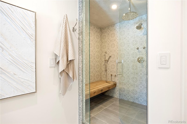 bathroom with tile patterned flooring and a walk in shower