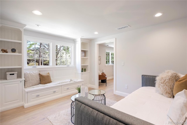 interior space with built in shelves, light wood-style floors, visible vents, and recessed lighting