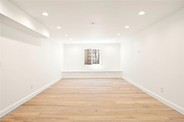 unfurnished room with recessed lighting, light wood finished floors, and baseboards