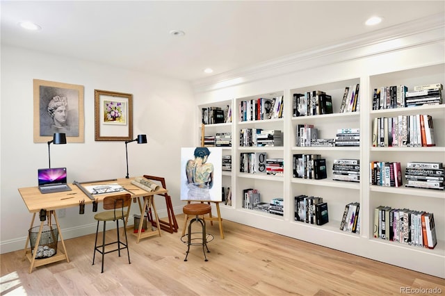 sitting room featuring baseboards, wood finished floors, and recessed lighting