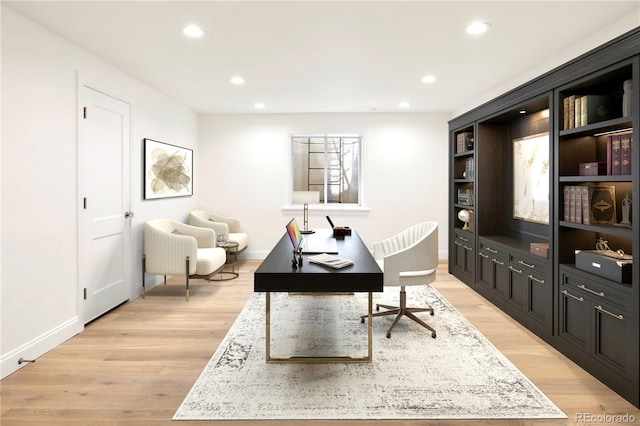 office featuring baseboards, recessed lighting, and light wood-style flooring