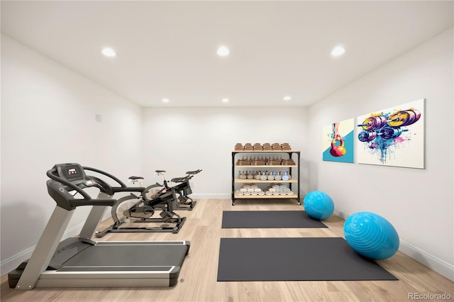 exercise area with wood finished floors, baseboards, and recessed lighting