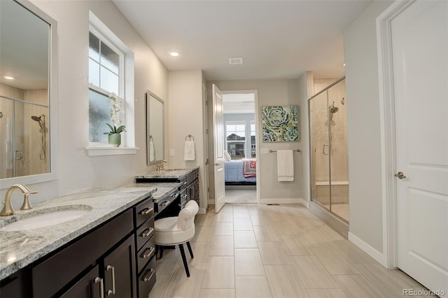 bathroom featuring vanity and a shower with shower door