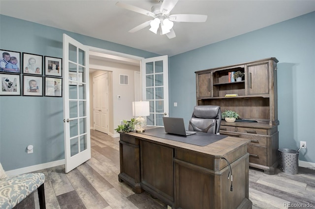 office space featuring light hardwood / wood-style flooring, ceiling fan, and french doors