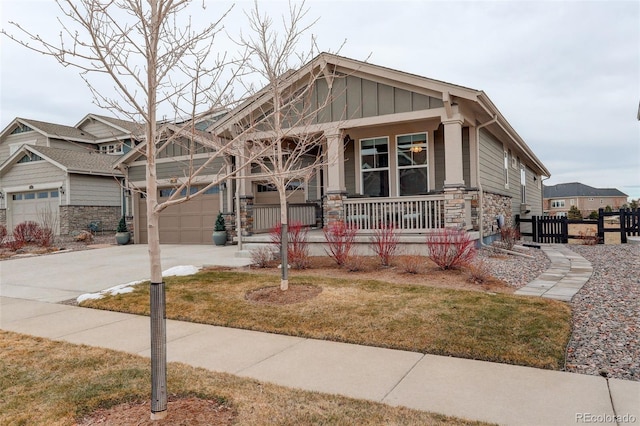 craftsman-style home with a porch, a garage, and a front yard