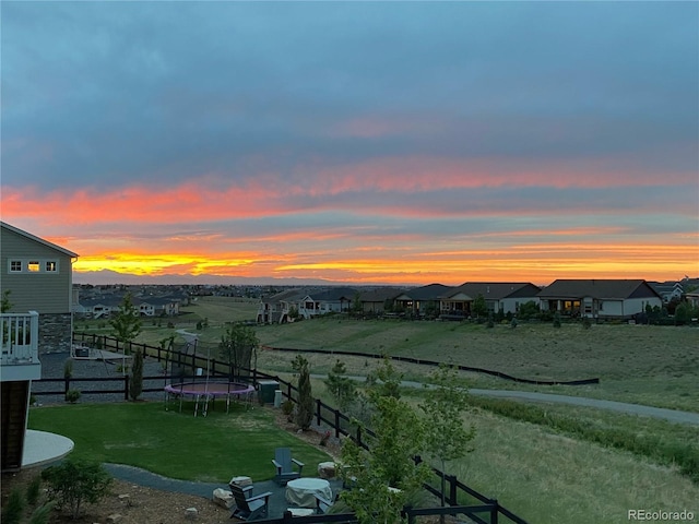 yard at dusk with a trampoline