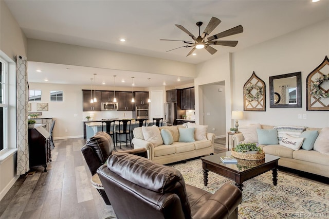 living room with hardwood / wood-style floors and ceiling fan