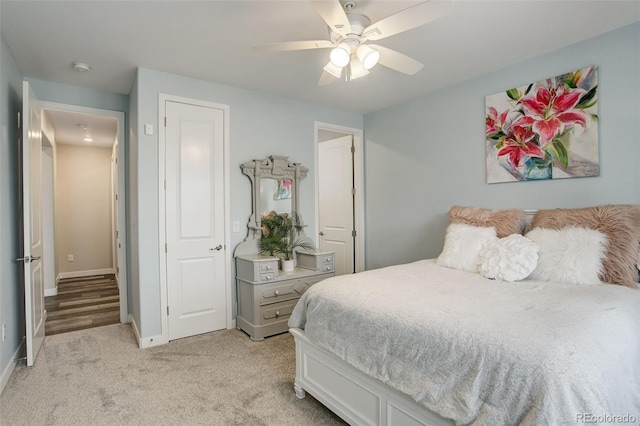 bedroom featuring light carpet and ceiling fan