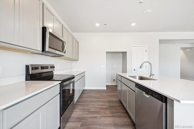 19079 E 94th Pl, Commerce City, CO 80022 - kitchen with stainless steel appliances, light countertops, dark wood-type flooring, gray cabinetry, and recessed lighting