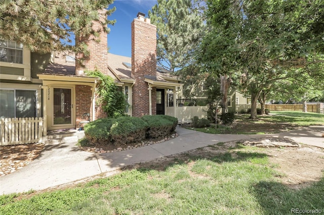 2021 S Hannibal Way Unit F, Aurora, CO 80013 - view of front facade with a chimney, brick siding, and a shingled roof