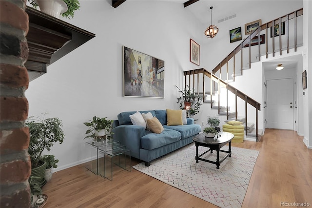 2021 S Hannibal Way Unit F, Aurora, CO 80013 - living room with wood finished floors, stairway, high vaulted ceiling, and a chandelier