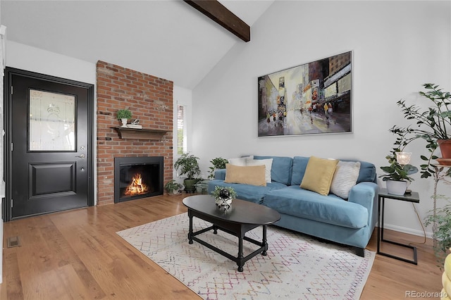 2021 S Hannibal Way Unit F, Aurora, CO 80013 - living area featuring wood finished floors, beamed ceiling, a fireplace, and high vaulted ceiling