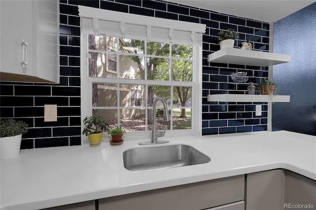 2021 S Hannibal Way Unit F, Aurora, CO 80013 - kitchen with open shelves, light countertops, white cabinetry, and backsplash
