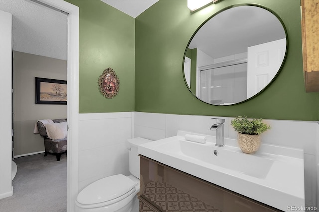 2021 S Hannibal Way Unit F, Aurora, CO 80013 - full bathroom with vanity, a shower with door, and a wainscoted wall