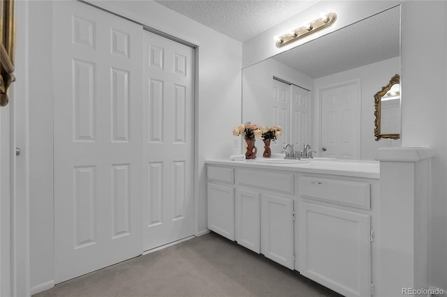2021 S Hannibal Way Unit F, Aurora, CO 80013 - bathroom with a textured ceiling and vanity