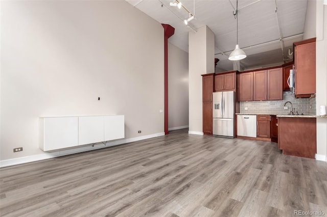 720 16th St Unit 207, Denver, CO 80202 - kitchen with dishwasher, fridge with ice dispenser, high vaulted ceiling, open floor plan, and backsplash