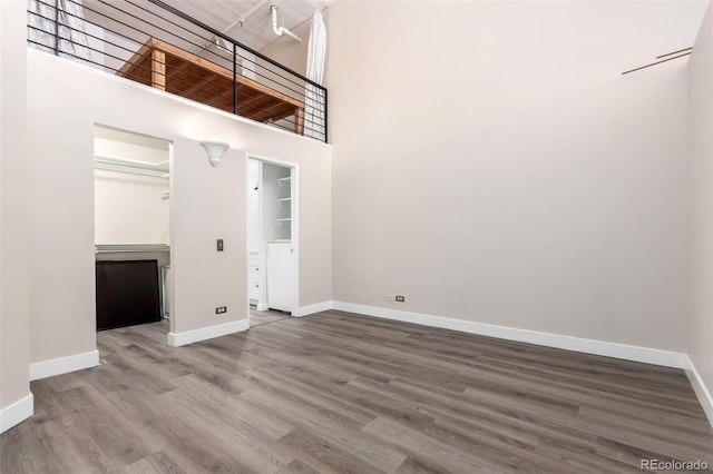 720 16th St Unit 207, Denver, CO 80202 - unfurnished room featuring a towering ceiling and wood finished floors