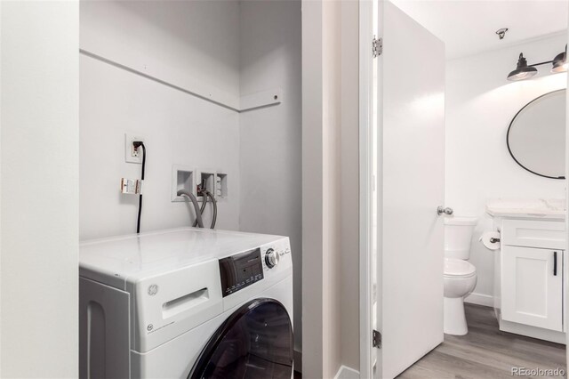 720 16th St Unit 207, Denver, CO 80202 - laundry room featuring washer / dryer and light wood finished floors