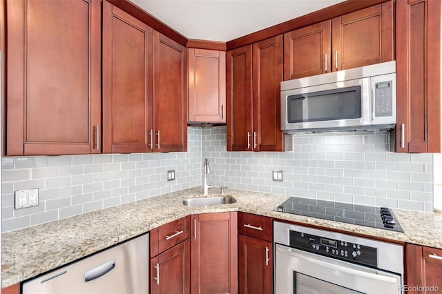 720 16th St Unit 207, Denver, CO 80202 - kitchen featuring appliances with stainless steel finishes, decorative backsplash, and light stone countertops