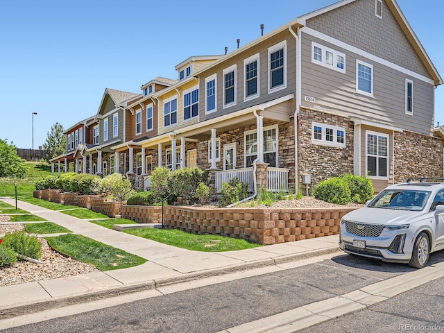 13638 Garfield St Unit C, Thornton, CO 80602 - townhome / multi-family property with stone siding and covered porch