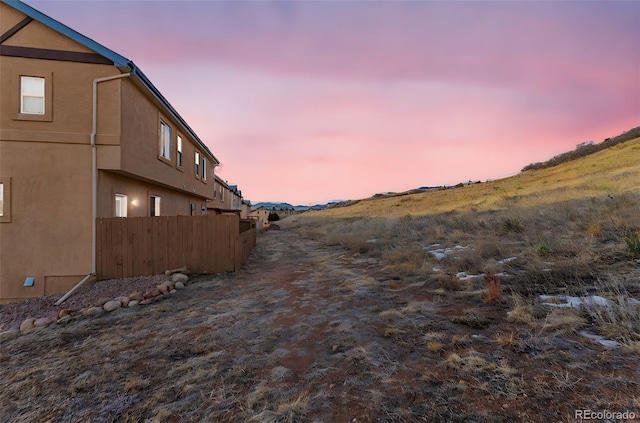 exterior space with fence and stucco siding