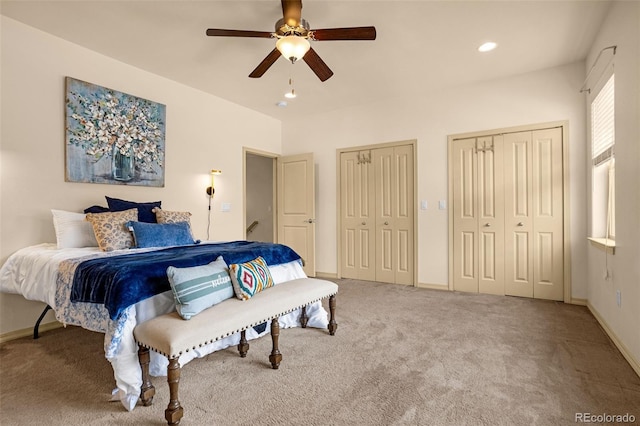 carpeted bedroom featuring recessed lighting, baseboards, multiple closets, and a ceiling fan