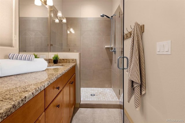 full bath with tile patterned floors, a stall shower, and vanity