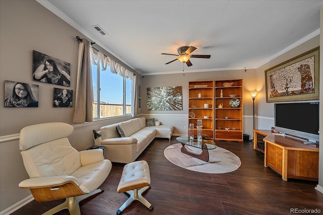 living room with crown molding, ceiling fan, and dark hardwood / wood-style floors