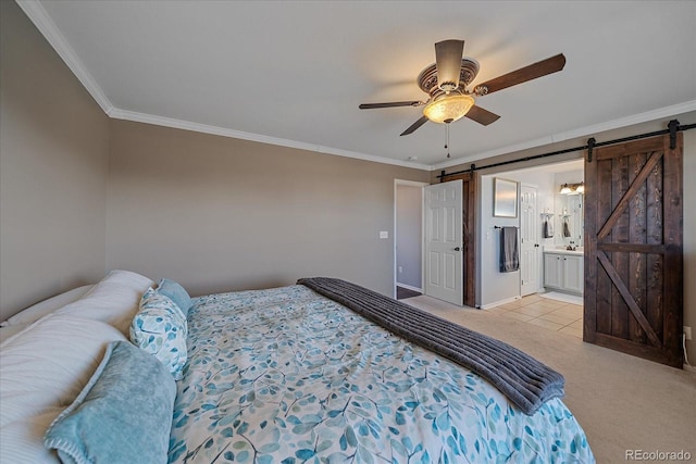 bedroom featuring ensuite bathroom, ornamental molding, light colored carpet, ceiling fan, and a barn door