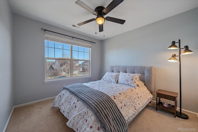 bedroom with light carpet and ceiling fan