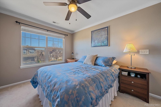 carpeted bedroom with ornamental molding and ceiling fan