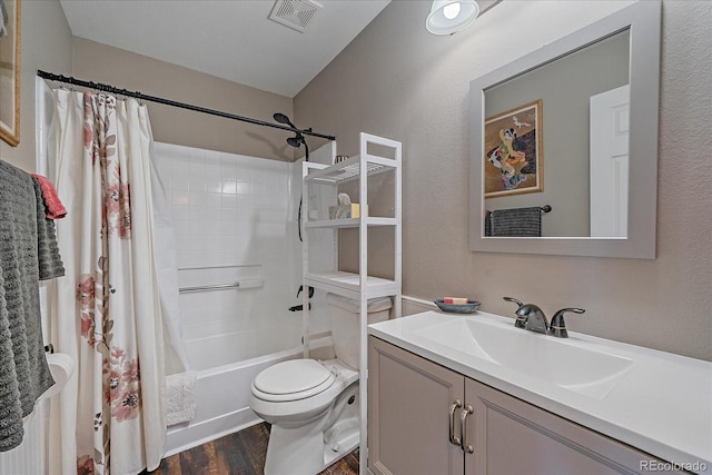 full bathroom with vanity, hardwood / wood-style flooring, shower / bath combination with curtain, and toilet