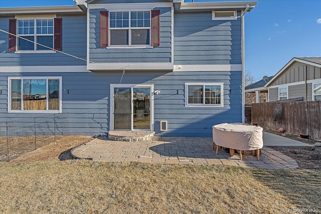 rear view of property with a patio area and a lawn