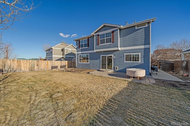 rear view of property with a yard and a patio