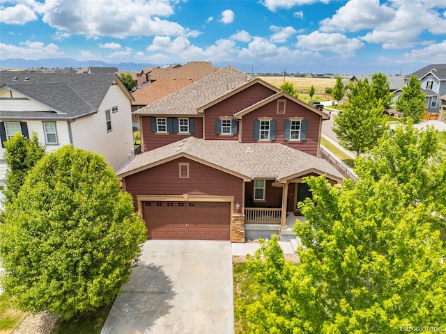 3535 Raintree Ln, Dacono, CO 80514 - view of front facade featuring concrete driveway, roof with shingles, a residential view, and a porch