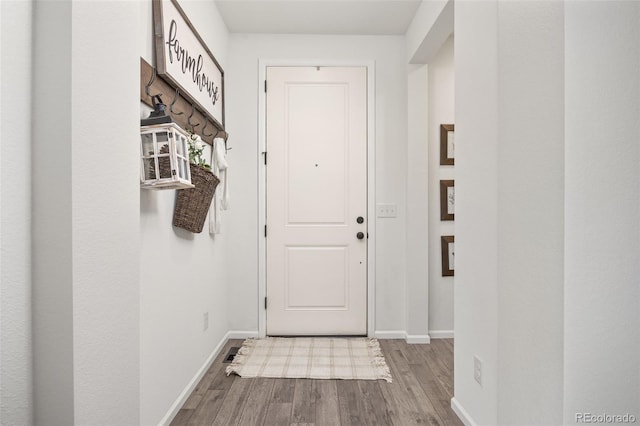 3535 Raintree Ln, Dacono, CO 80514 - doorway with wood finished floors and baseboards