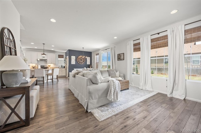 3535 Raintree Ln, Dacono, CO 80514 - living room with dark wood-type flooring, a chandelier, and recessed lighting